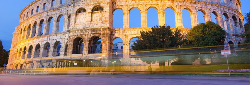 Colosseum i Pula, tatt i skumringen med lang eksponeringstid, viser lysstriper fra en buss.